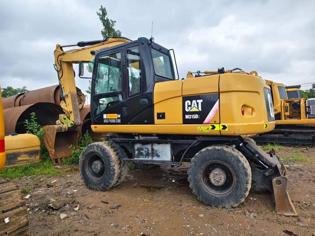 Pelle sur pneus Caterpillar M 315 D — occasion 2023, 1 012 h