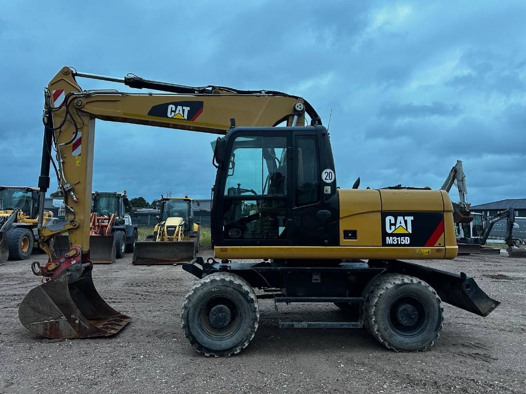 Pelle sur pneus Caterpillar M 315 D 30Km full Hydr. Top Zustand German machine — occasion 2014, 9 653 h