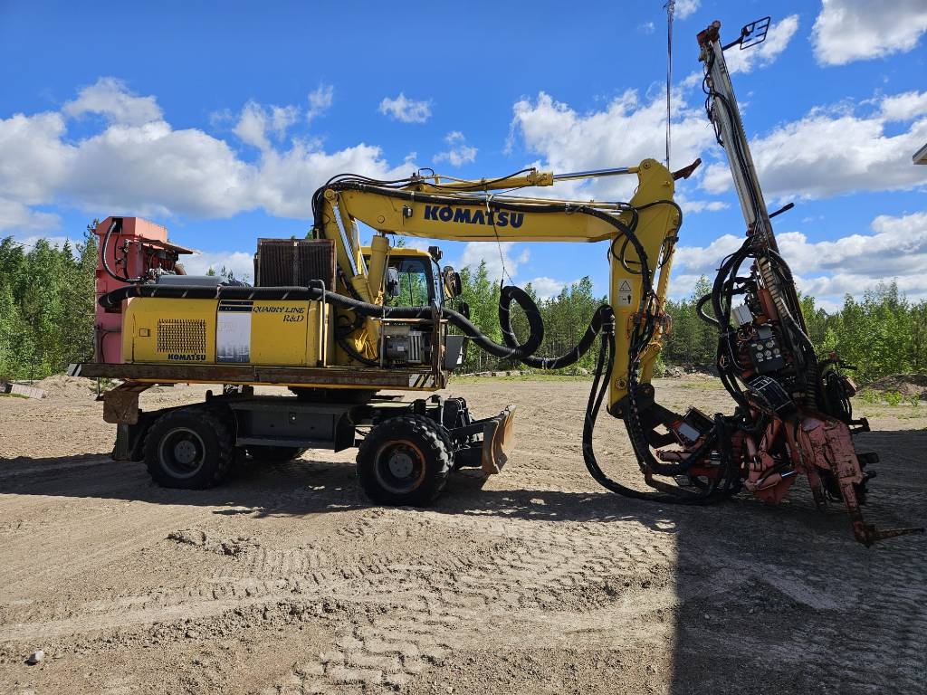 Sandvik DQ 240 ja Komatsu PW 180-7K
