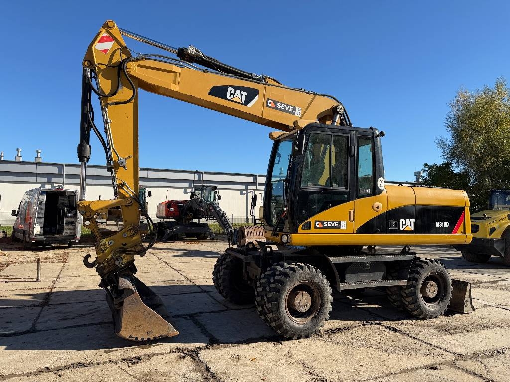 Pelle sur pneus Caterpillar M 318 D — occasion 2009, 13 199 h