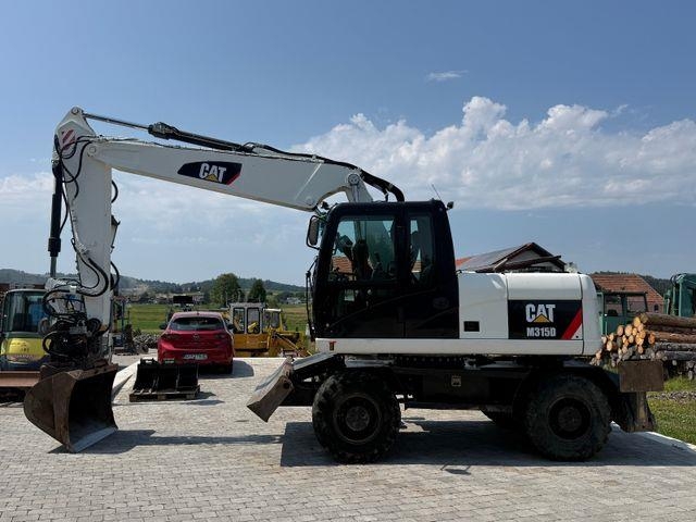 Pelle sur pneus Caterpillar M315D mit Powertilt — occasion 2011, 9 900 h
