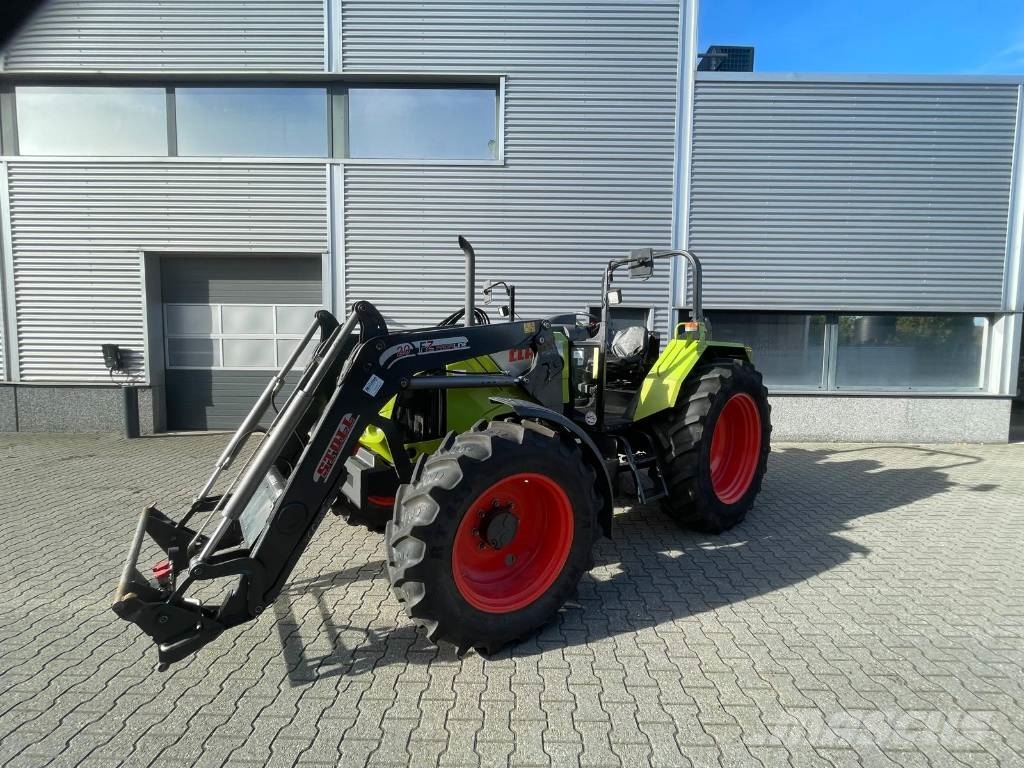 CLAAS Axos 340 tractor met Stoll voorlader Трактори
