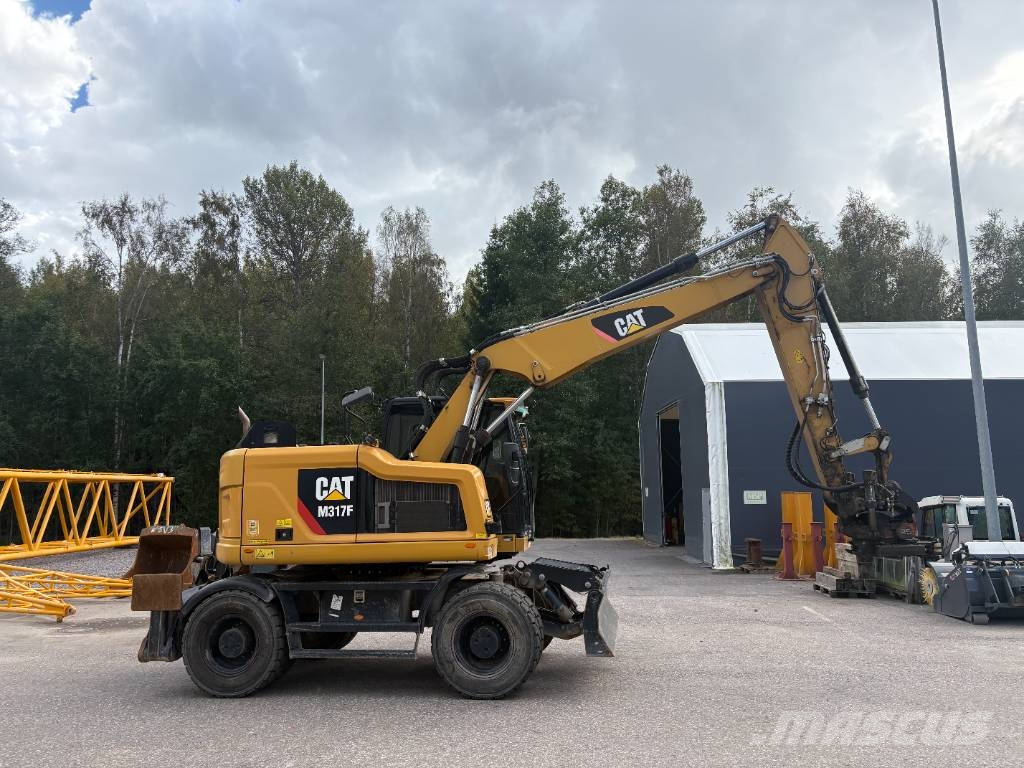 CAT M 317 حفارات بعجل