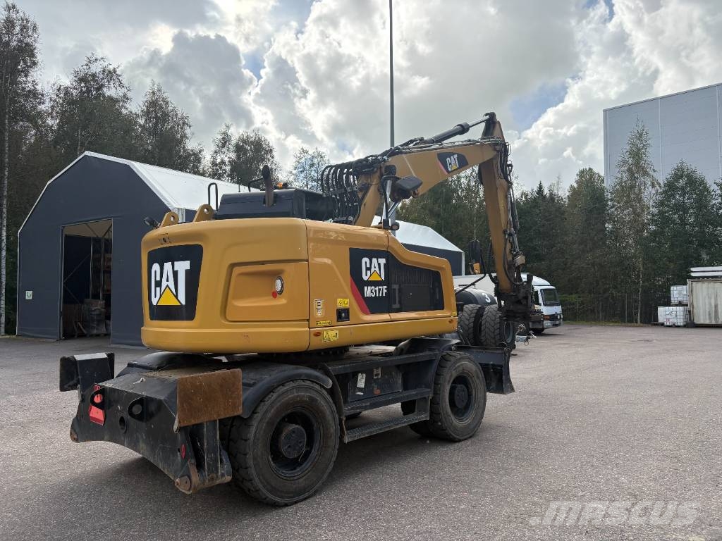 CAT M 317 حفارات بعجل