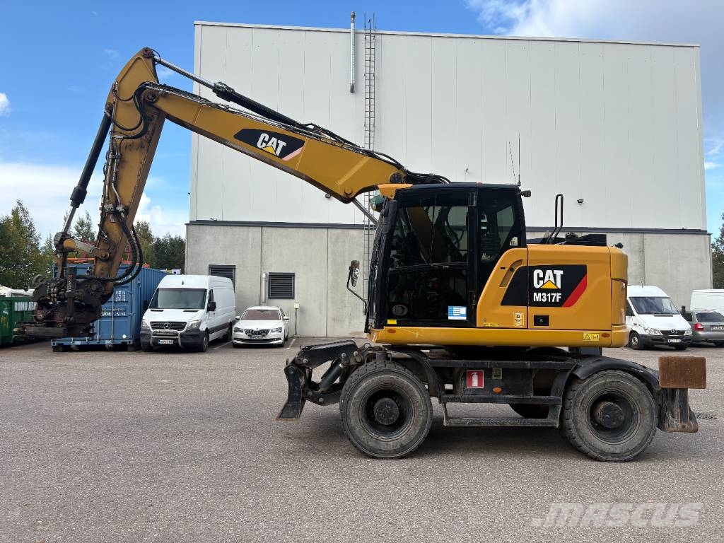CAT M 317 حفارات بعجل