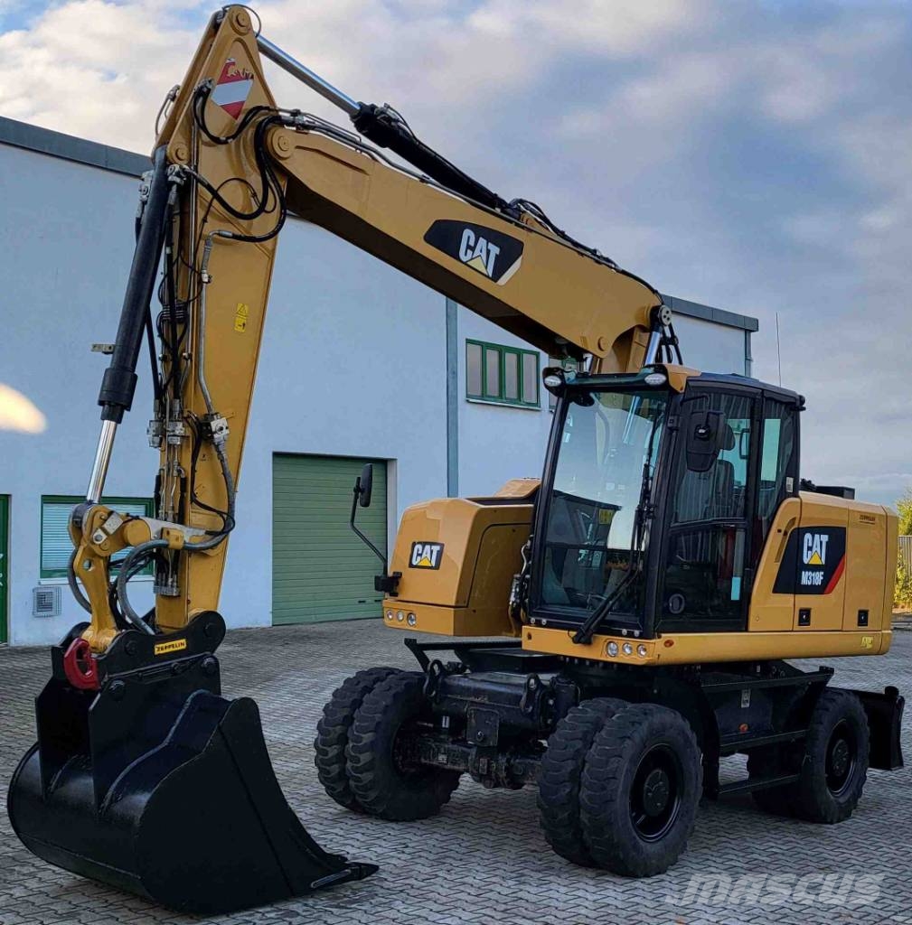 CAT M 318 F حفارات بعجل