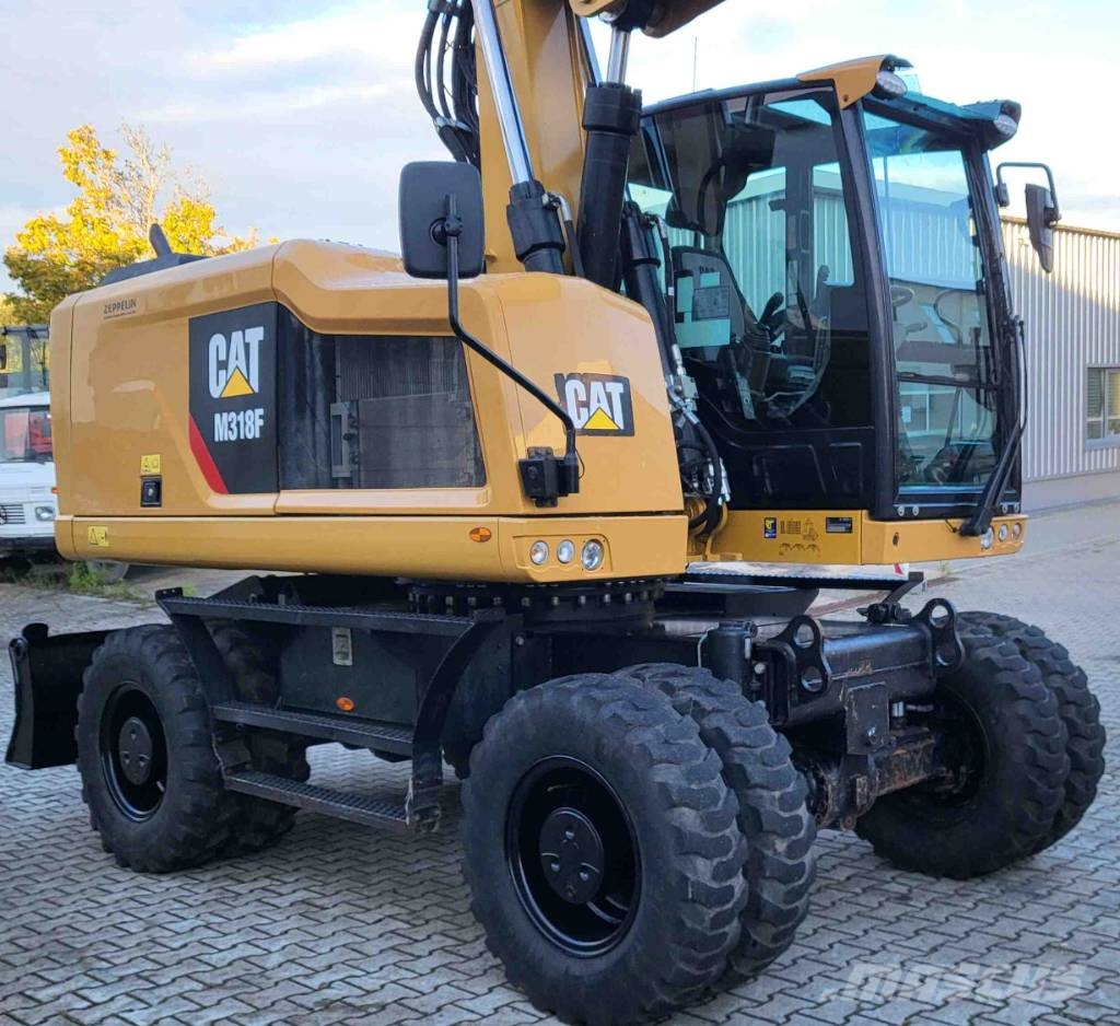 CAT M 318 F حفارات بعجل