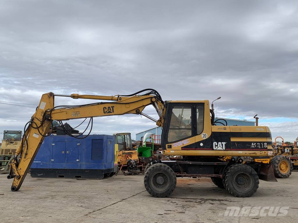 CAT M 318 حفارات بعجل