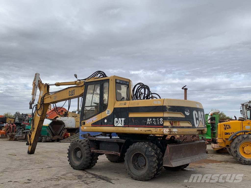 CAT M 318 حفارات بعجل