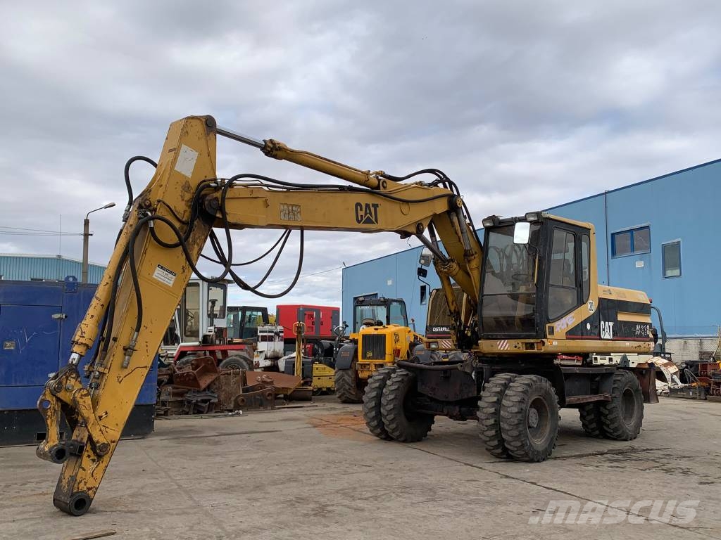 CAT M 318 حفارات بعجل