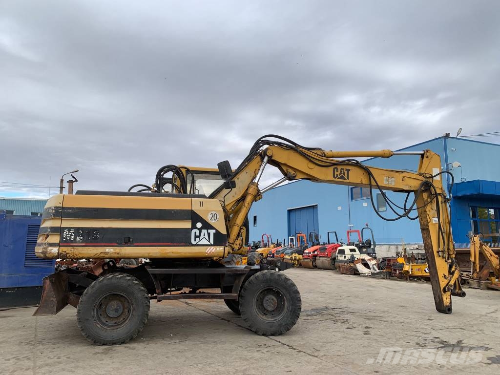 CAT M 318 حفارات بعجل