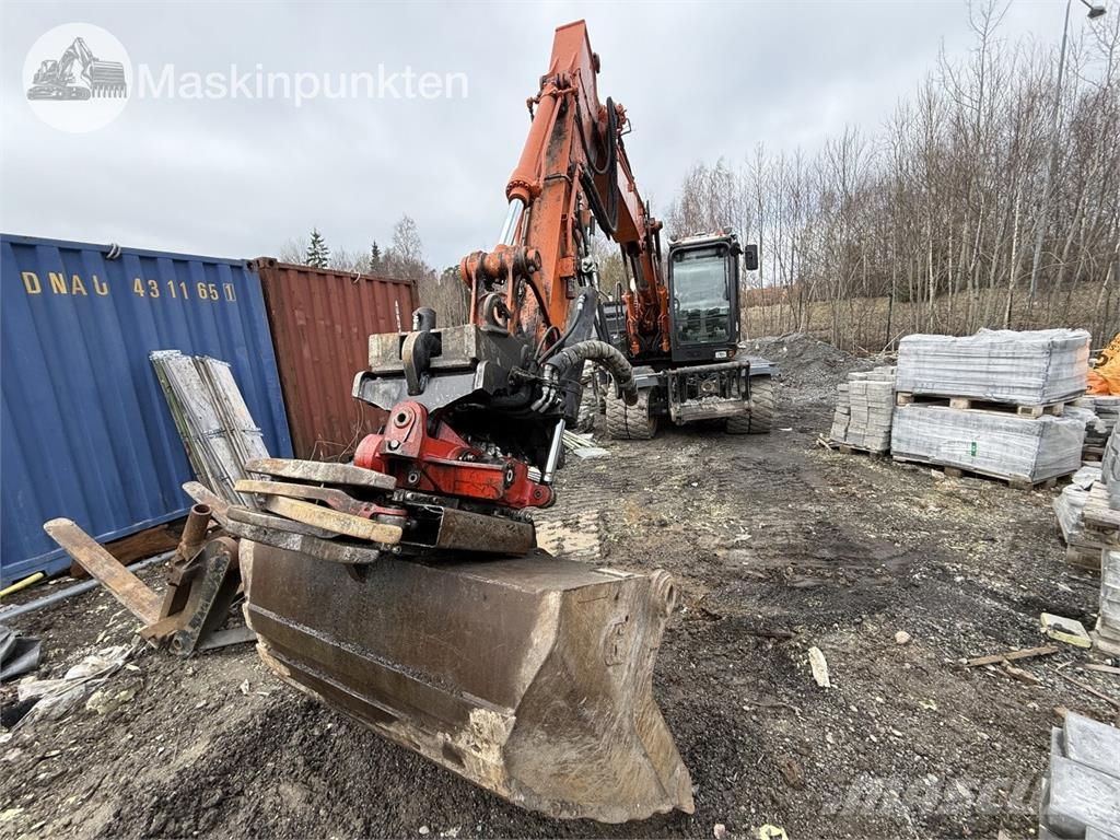 Hitachi ZX 140W-5B حفارات بعجل