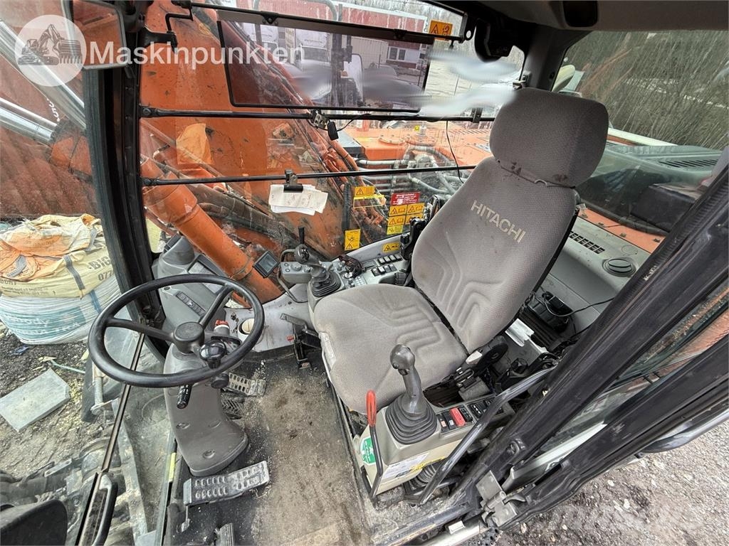 Hitachi ZX 140W-5B حفارات بعجل