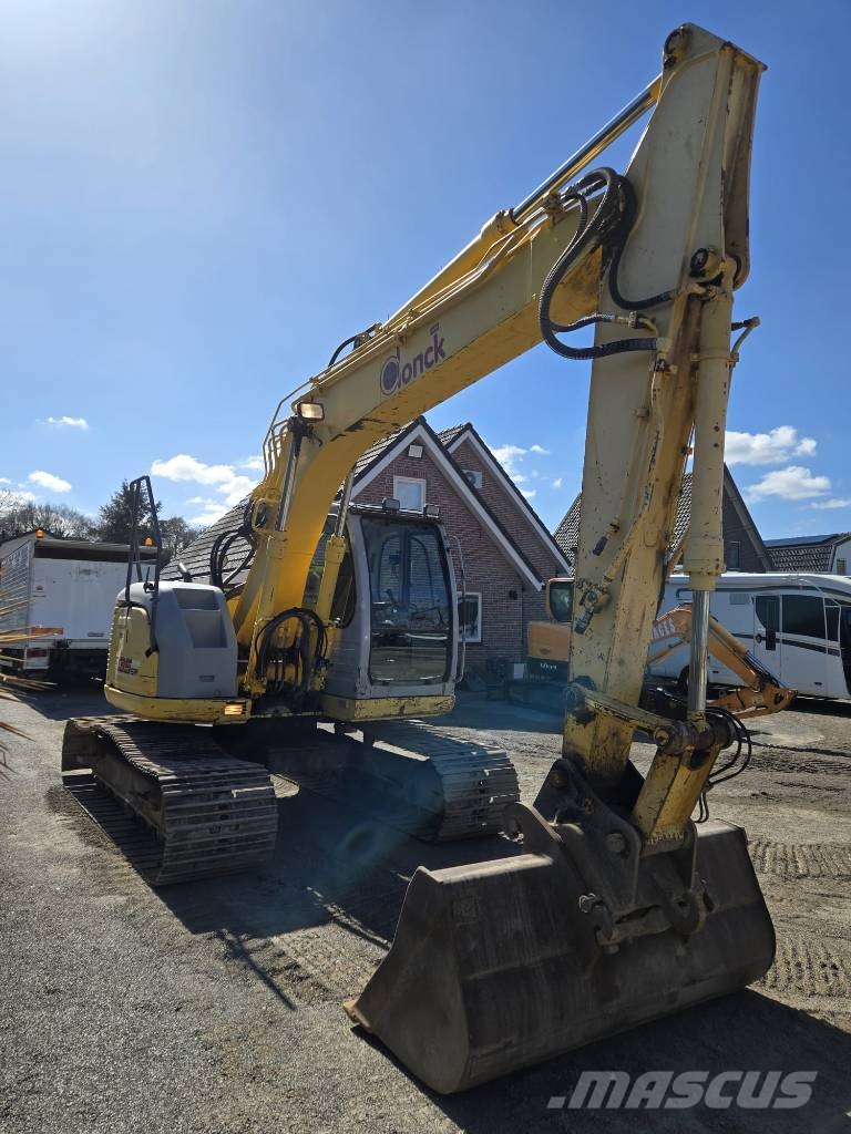 New Holland E 135 SR Bageri guseničari