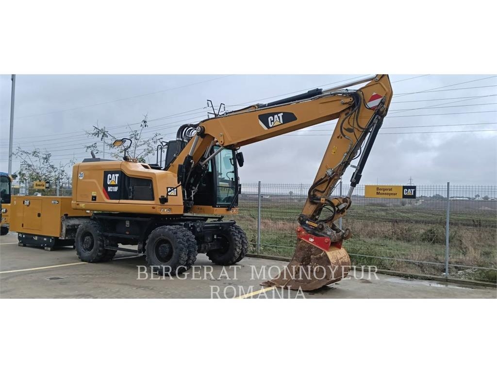 CAT M318F Pelle sur pneus