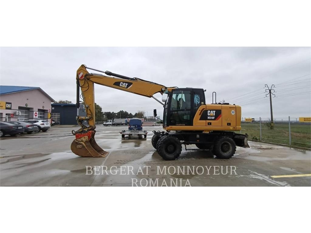 CAT M318F Pelle sur pneus