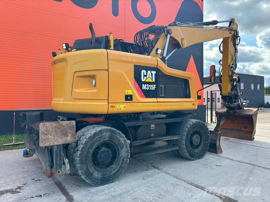CAT M 315 F TILTROTATOR / AC / CENTRAL LUBRICATION Gumikerekes kotrók