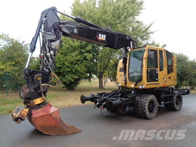 CAT M323 ZW RAIL mit Encon Tiltrotator Wielgraafmachines