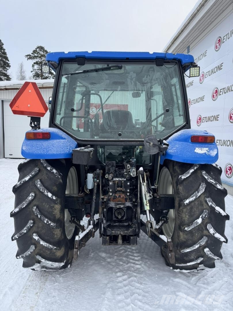 New Holland TL100A DC + Etukuorm. Traktoriai