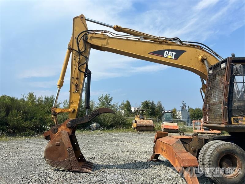 CAT M318C Ekskavatori uz riteņiem