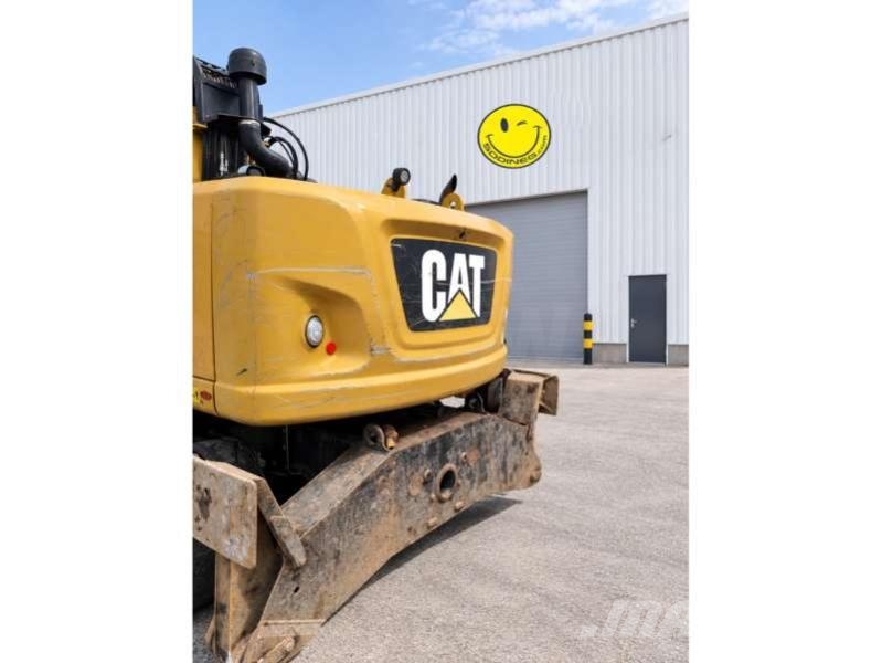 CAT MH3024 + grappin Materialumschlag
